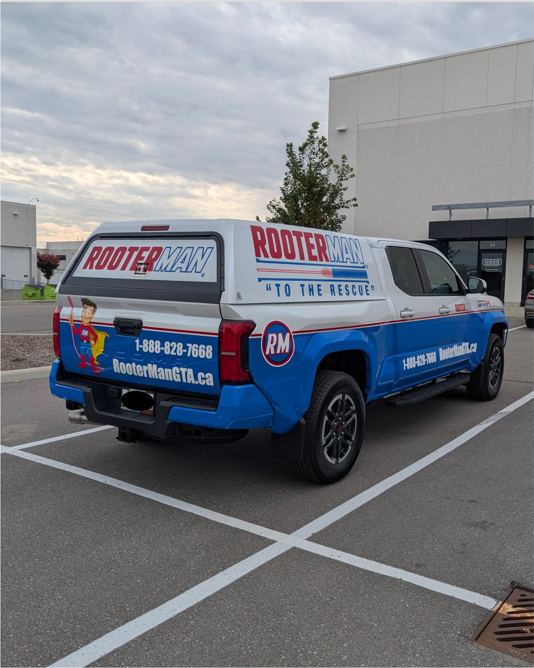 Full commercial truck wrap for RooterMan GTA featuring bold blue and white branding with mascot.