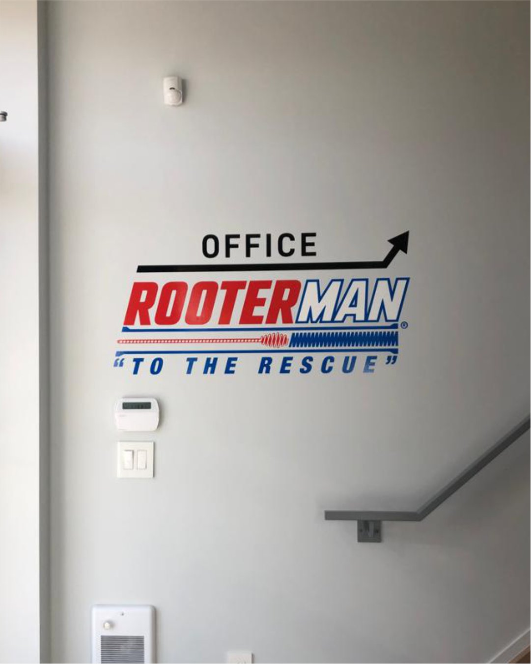 RooterMan-Office-Directional-Wall-Graphic. Custom vinyl wall graphic for RooterMan office directional signage with "TO THE RESCUE" slogan.