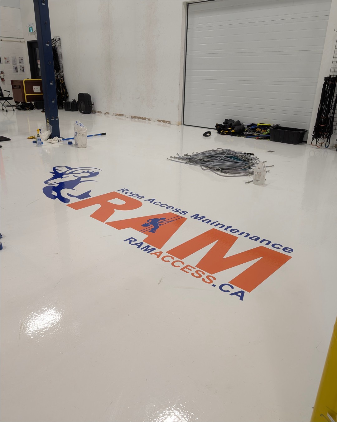 RAM-Access-Loading-Bay-Floor-Graphic RAM Access Maintenance floor branding logo installed near the facility loading bay door in Burlington.